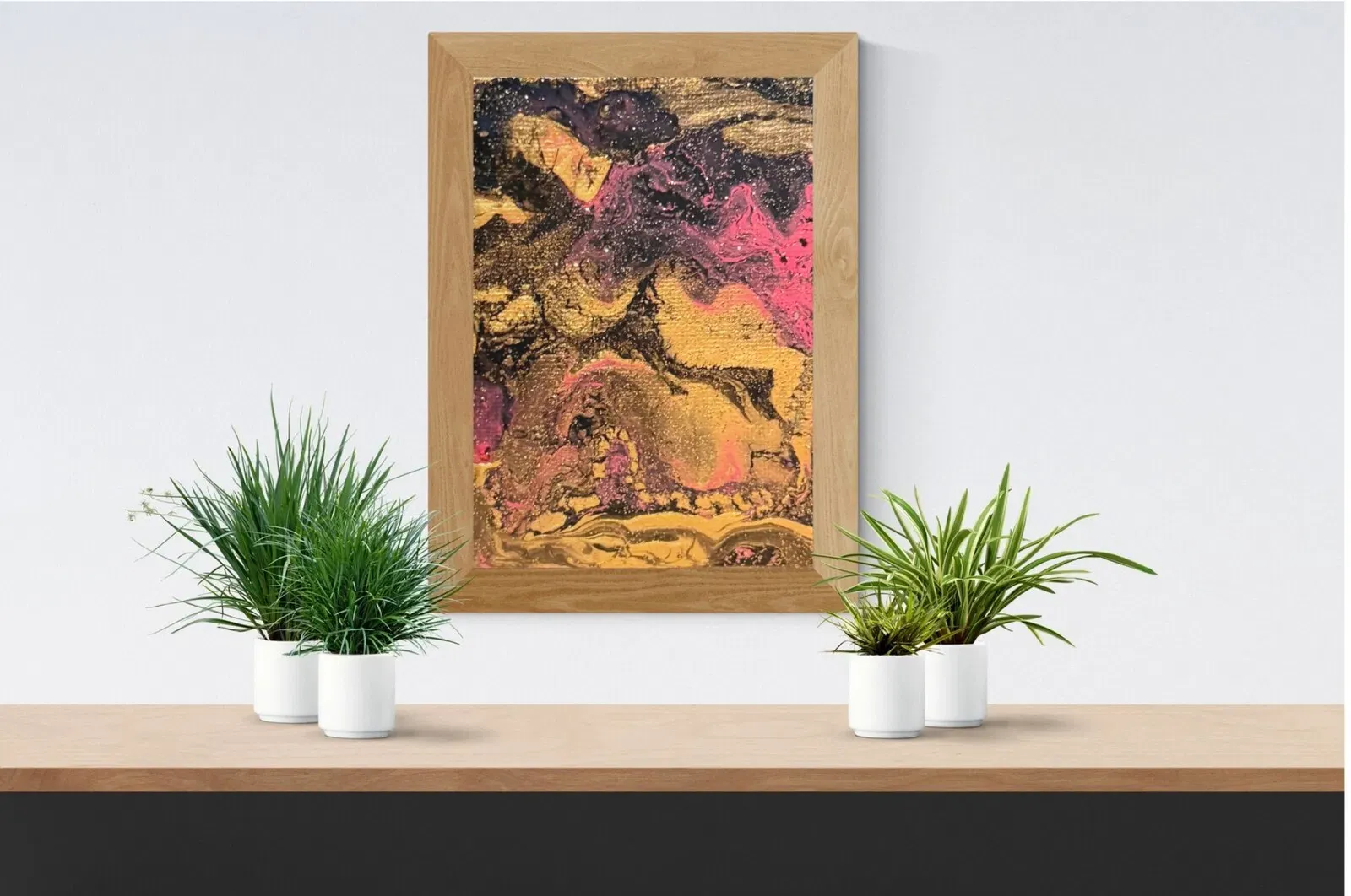Handmade abstract acrylic pour art in magenta, gold, and black